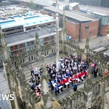 School choir sings on top of Hull Minster tower