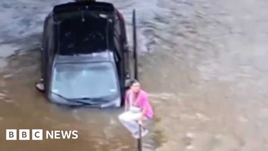 Woman escapes car after driving into floods in Texas