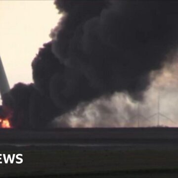 Wind turbine snapped and burning after Iowa tornado