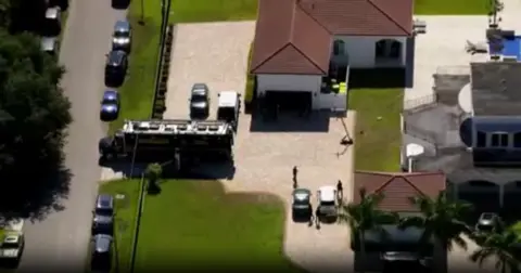 WFOR/CBS News Police cars near house