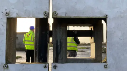 Workers behind gates at Casement Park Stadium