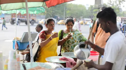 EPA-EFE/REX/Shutterstock n Indian street vendor sells curd sarbat on a sidewalk during a hot afternoon in Kolkata, eastern India, 16 May 2024. The summer or pre-monsoon season lasts from March to July in eastern India with the highest day temperatures ranging from 38 to 45 degrees Celsius. Kolkata residents battle heat wave, India - 16 May 2024