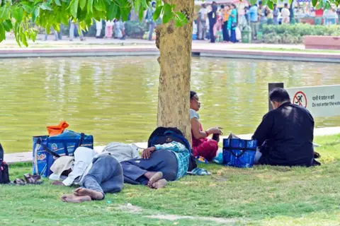 Getty Images NEW DELHI, INDIA - MAY 12: Visitors seen out on a hot afternoon at India Gate, on May 12, 2024 in New Delhi, India. (Photo by Sanjeev Verma/Hindustan Times via Getty Images)