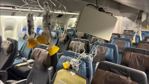 Reuters The plane seats with emergency oxygen masks down and people's belongings strewn about