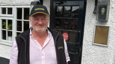 Brian Farmer/BBC Graham Smith-Bernal outside the Fox & Hounds pub