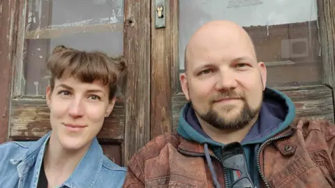 Handout Man and woman smiling at camera