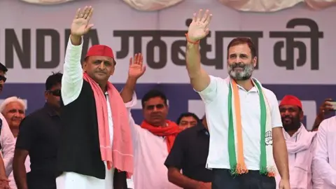 Getty Images Akhilesh Yadav (left) and Rahul Gandhi wave at an election rally in UP