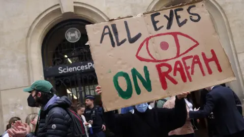 Reuters Students occupy the street in front of the Sciences Po University building in support of Palestinians in Gaza, amid the ongoing conflict between Israel and the Palestinian Islamist group Hamas, in Paris, France, May 7, 2024. The slogan reads "All eyes on Rafah". REUTERS/Johanna Geron
