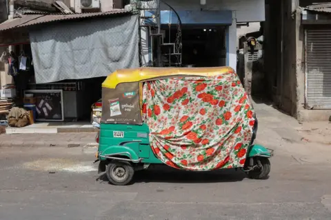 Reuters An autorickshaw covered with a cloth during a heat wave in Ahmedabad