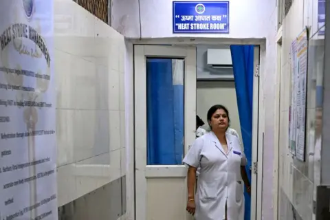 Getty Images A medical staff walks out of a heat stroke room at the Ram Manohar Lohia hospital in New Delhi on May 30, 2024. In Delhi's Ram Manohar Lohia hospital, a specialised unit is busy treating patients with heat-related illnesses. Equipped with immersion ice baths, the unit has treated eight heat-struck patients in the past week. (Photo by Arun SANKAR / AFP) (Photo by ARUN SANKAR/AFP via Getty Images)