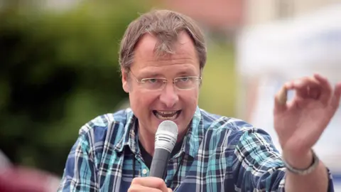 Getty Images Michael Stuerzenberger holds microphone gesturing with his hand in June 2015 in Pfaffenhofen an der Ilm, Germany. 