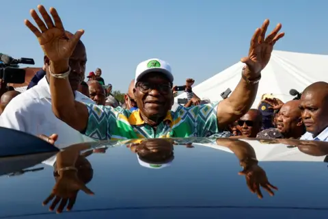 Rogan Ward/REUTERS Former South African President Jacob Zuma gestures after voting during the South African elections, in Nkandla, South Africa, 29 May  2024. 