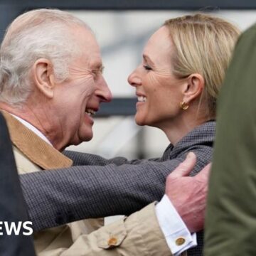 King hugs niece Zara at Windsor horse show after return to duties