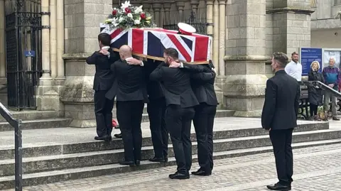 BBC Jim Henderson's coffin goes into Truro Cathedral