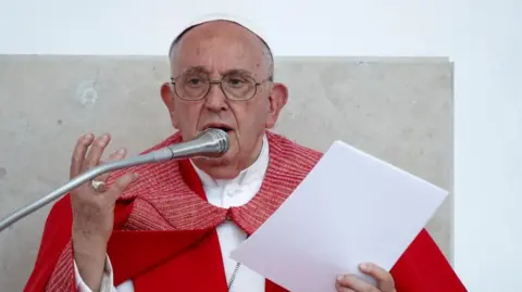 Reuters Pope Francis delivers a service. He is wearing a red robe.
