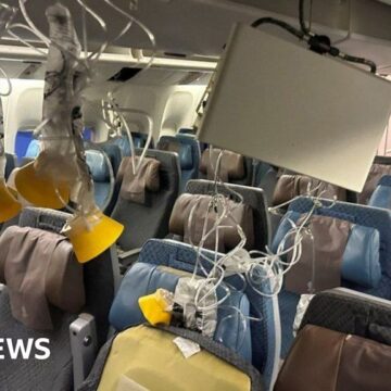 Singapore Airlines passenger walks through wrecked cabin