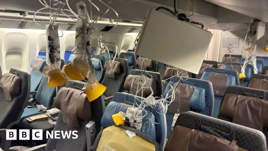 Singapore Airlines passenger walks through wrecked cabin