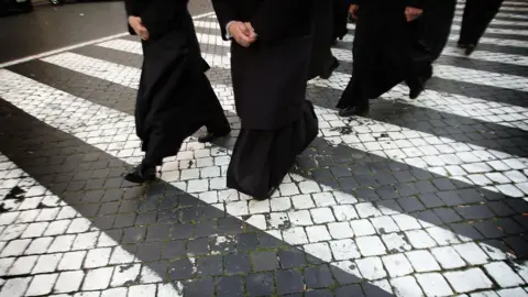 Getty Images Priests make their way to wait in line to view the body of Pope John Paul II as it lays in state in the St Peter's Basilica April 5, 2005 in Vatican City